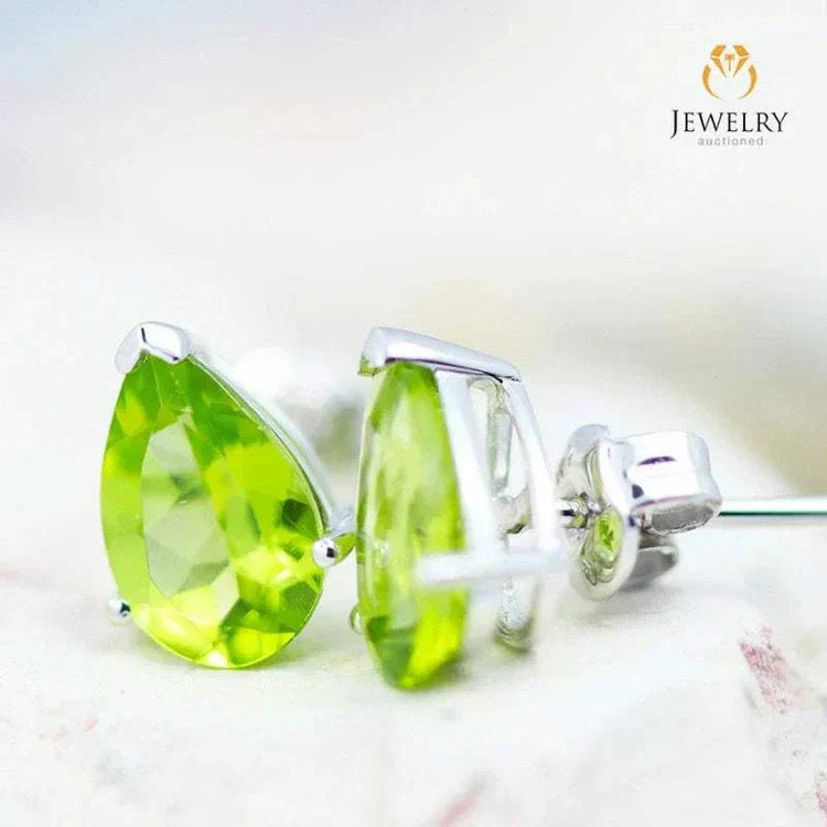 Natural peridot pear earrings in 14K white gold with faceted gemstones and hallmark.